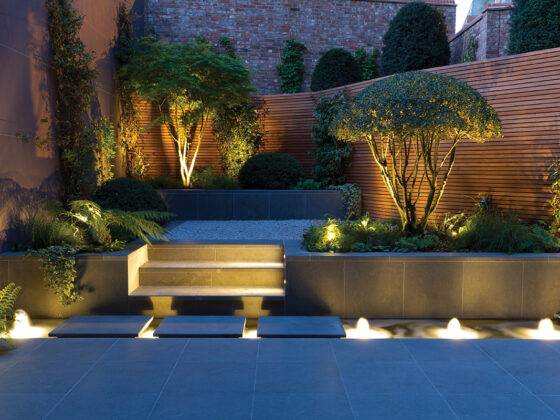 Custom lighting in a back yard by John Davies Landscape